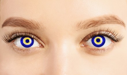 Image of Woman with pattern of Turkish nazar in her eyes, closeup. Protection against evil eye