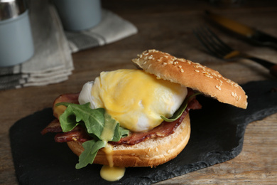 Delicious egg Benedict served on slate board, closeup