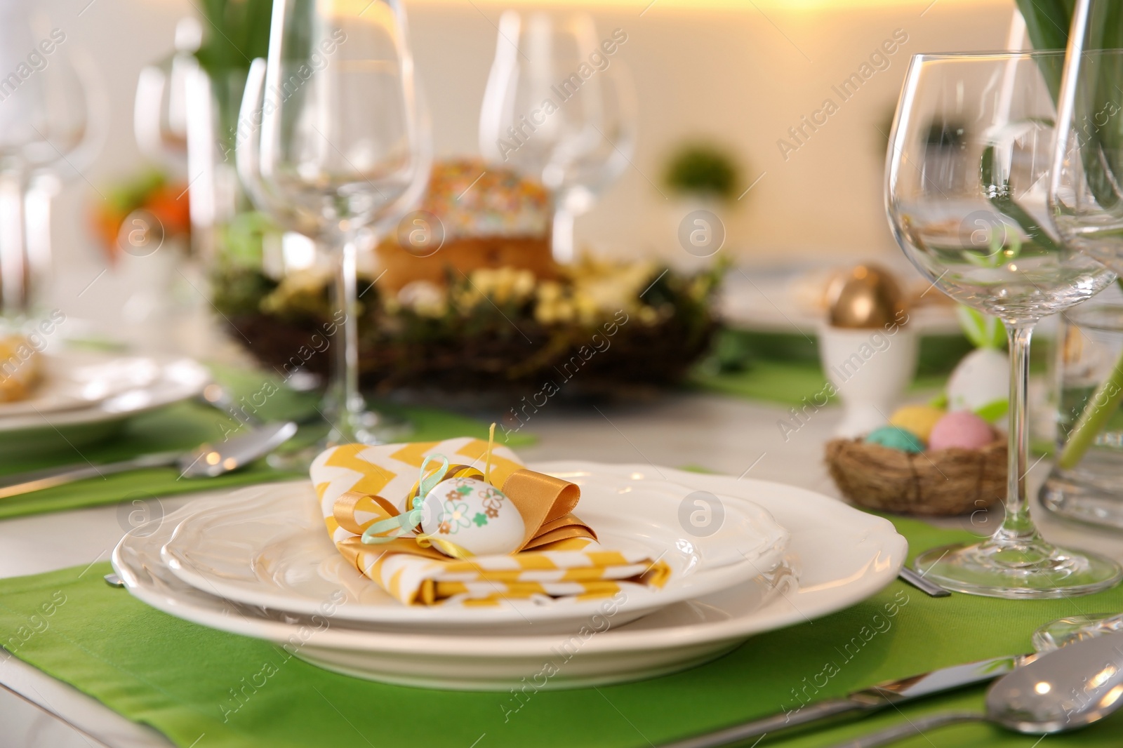 Photo of Festive Easter table setting with eggs, closeup