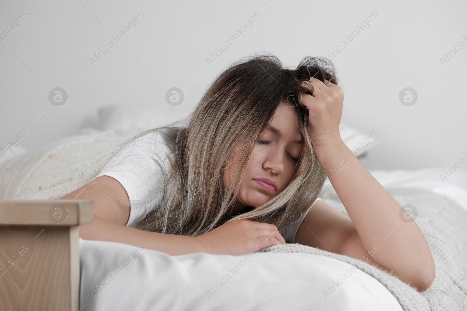 Photo of Sleepy young woman in bed at home