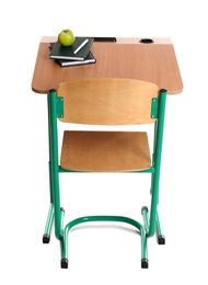 Photo of Wooden school desk with stationery and apple on white background