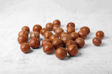 Delicious organic Macadamia nuts on white textured table