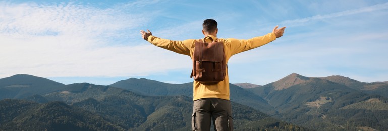 Image of Tourist in mountains on sunny day, back view. Banner design