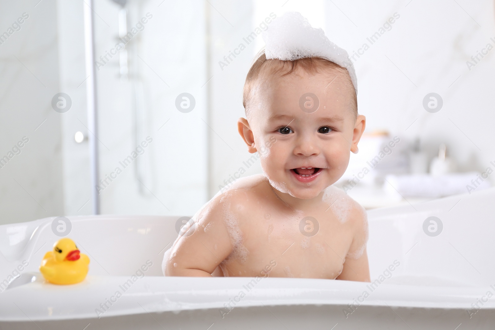 Photo of Cute little baby in bathtub at home