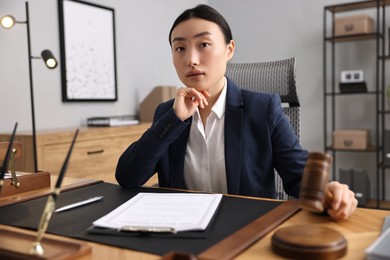 Photo of Notary with gavel at table in office