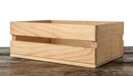 Empty rustic wooden crate on table against white background