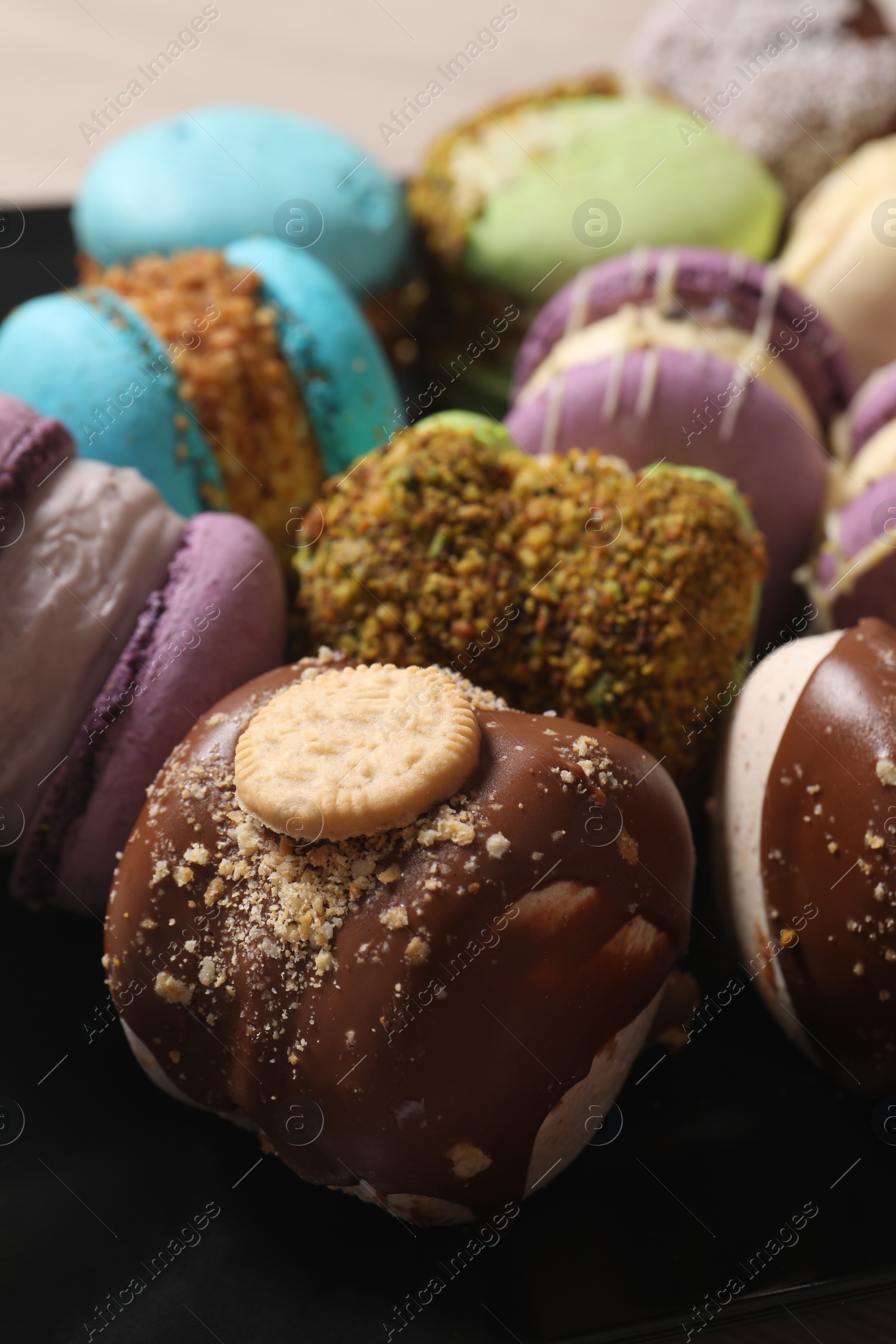 Photo of Delicious colorful macarons on plate, closeup view