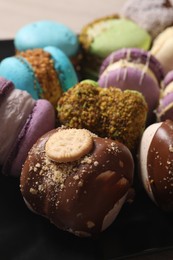 Photo of Delicious colorful macarons on plate, closeup view