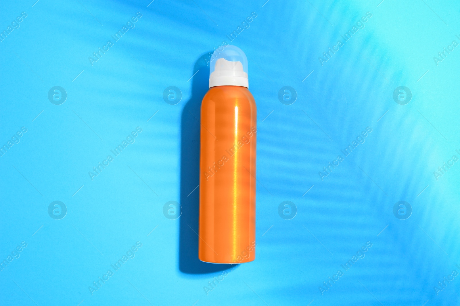 Photo of Sunscreen on light blue background, top view. Sun protection care