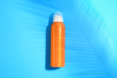 Photo of Sunscreen on light blue background, top view. Sun protection care