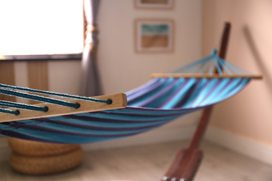 Photo of Comfortable blue hammock in stylish room. Interior design