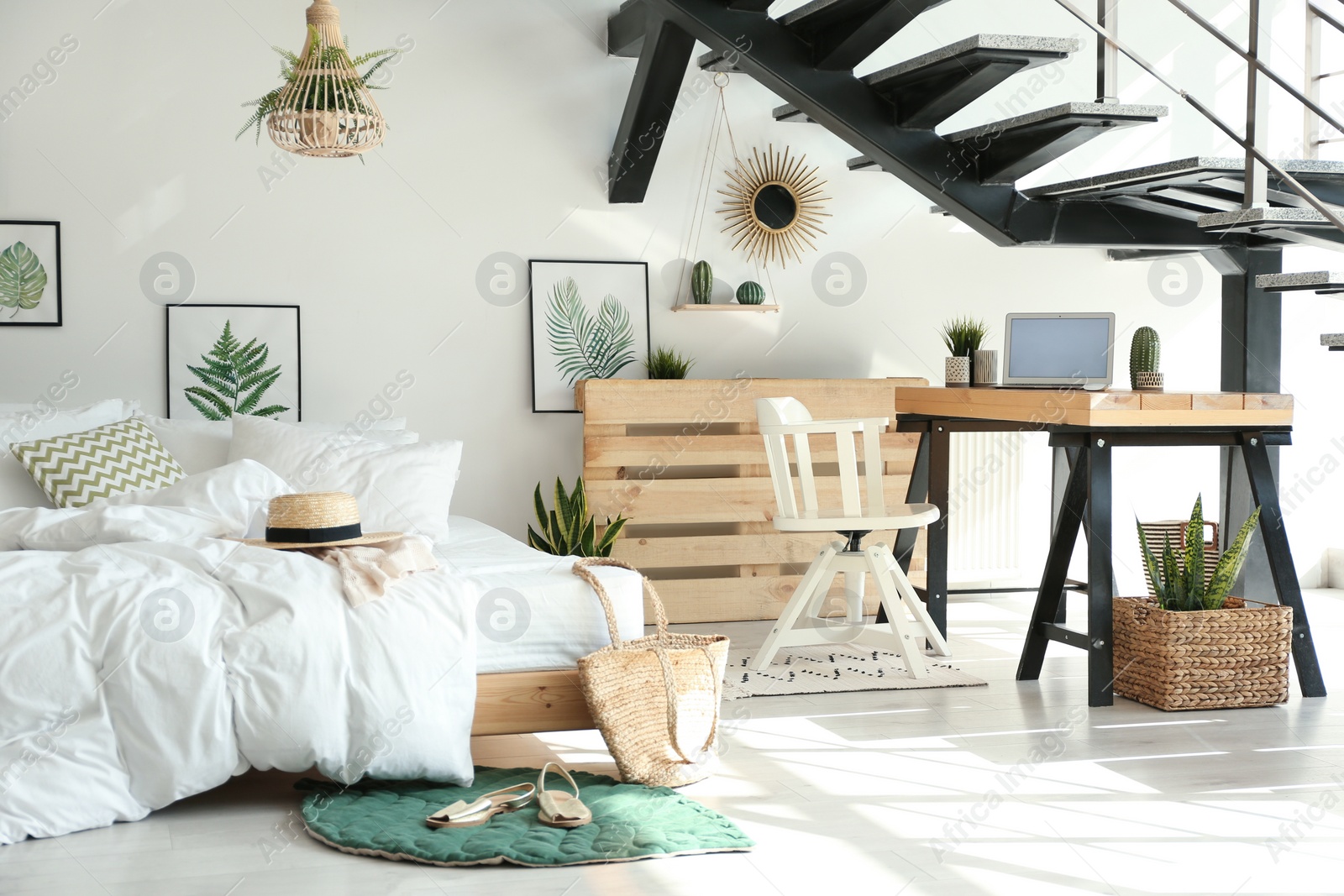 Photo of Elegant interior of bedroom with workplace under stairs