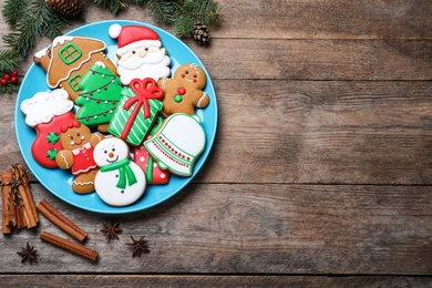 Photo of Delicious Christmas cookies on wooden table, flat lay. Space for text