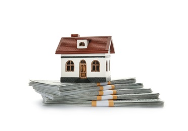 Photo of House model with money on white background