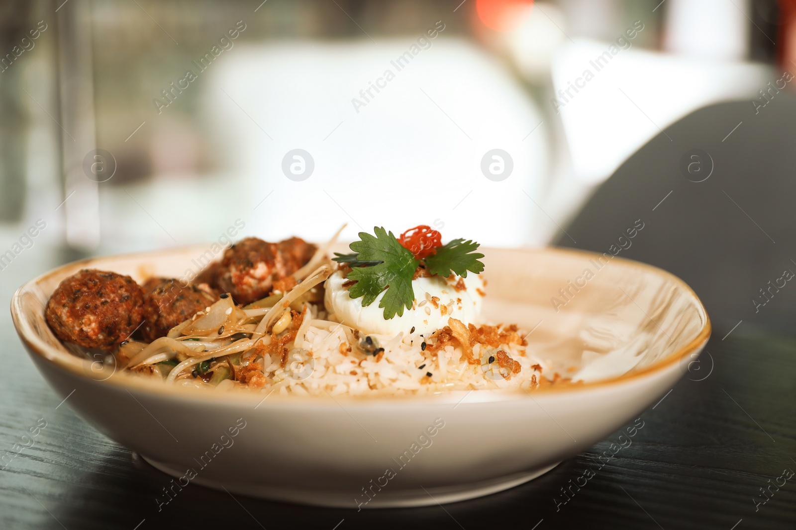 Photo of Plate with rice and meat balls served on table