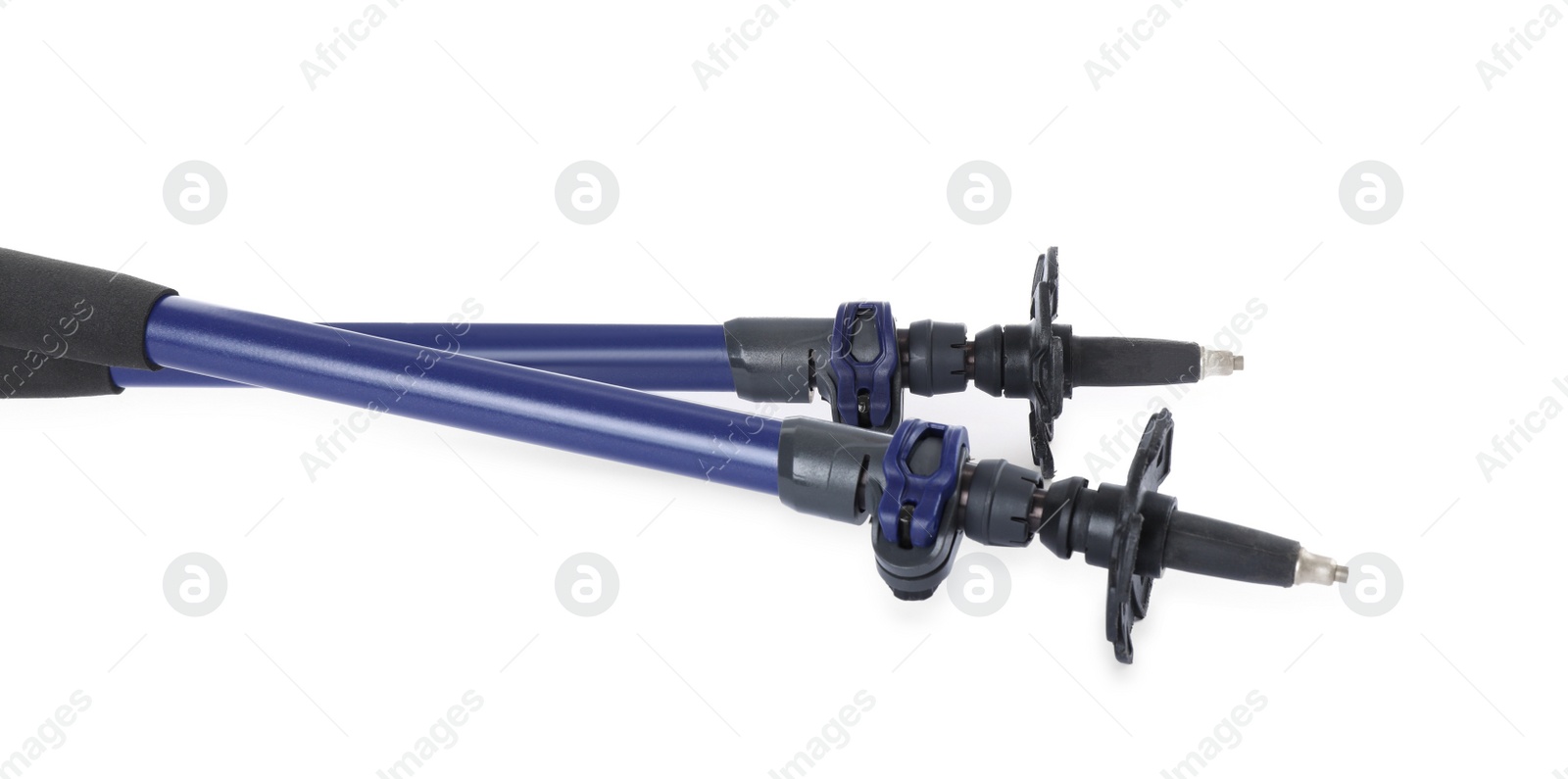 Photo of Pair of trekking poles on white background, closeup. Camping tourism