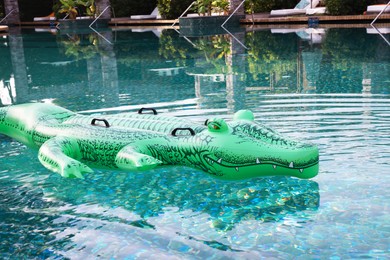 Photo of Float in shape of crocodile in swimming pool at luxury resort