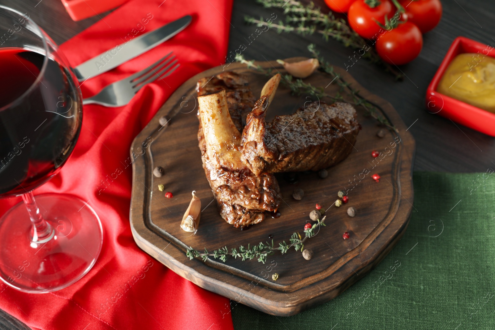 Photo of Delicious roasted ribs served on wooden table