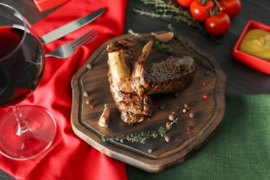 Delicious roasted ribs served on wooden table