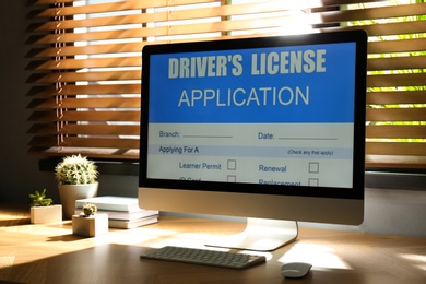 Computer with driver's license application form on table in office