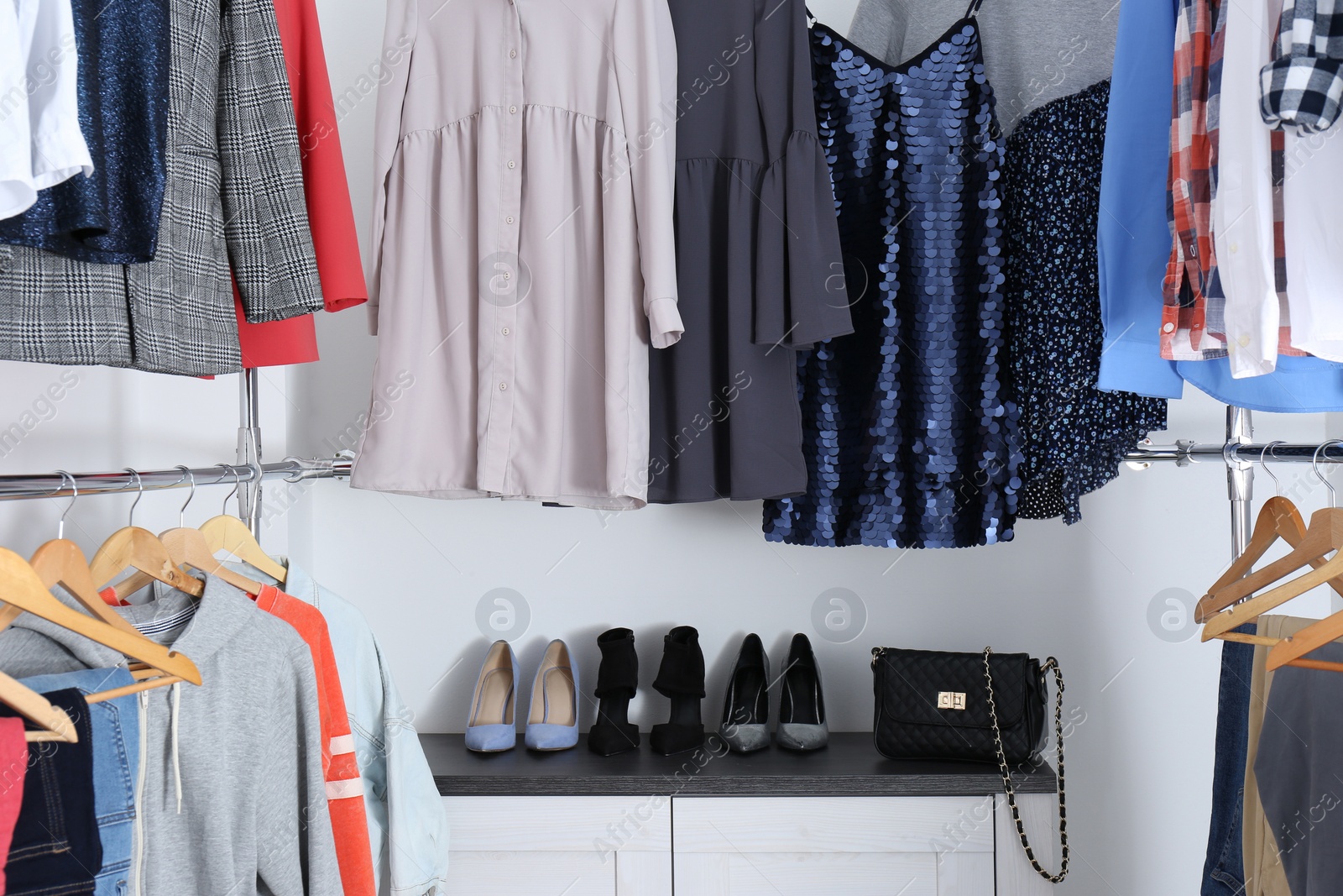 Photo of Modern dressing room with different stylish clothes and shoes