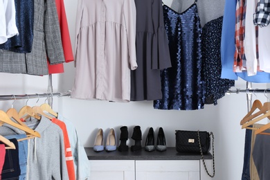 Modern dressing room with different stylish clothes and shoes