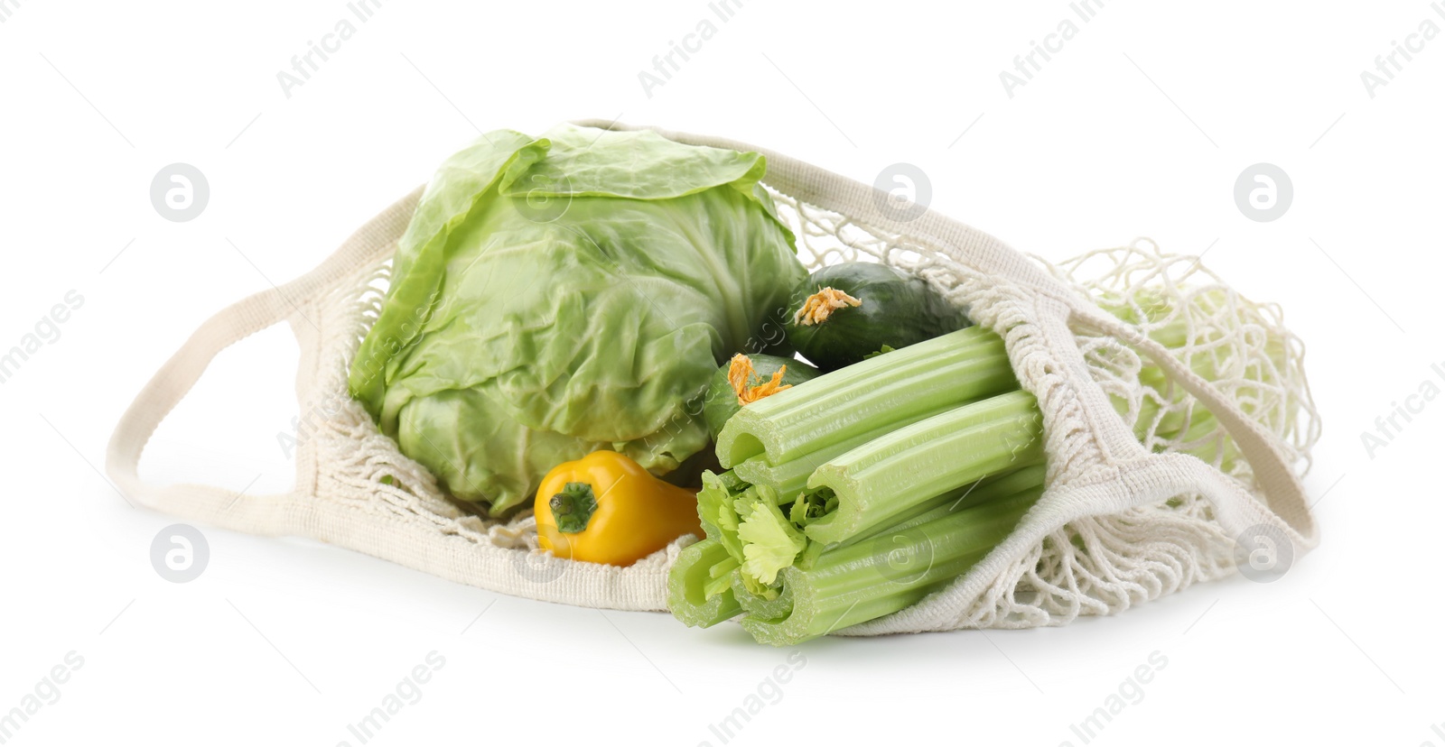 Photo of String bag with different vegetables isolated on white