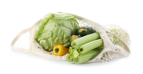 Photo of String bag with different vegetables isolated on white