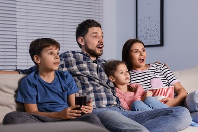 Family watching TV at home in evening