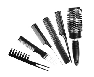 Photo of Set of modern hair combs and brush isolated on white, top view