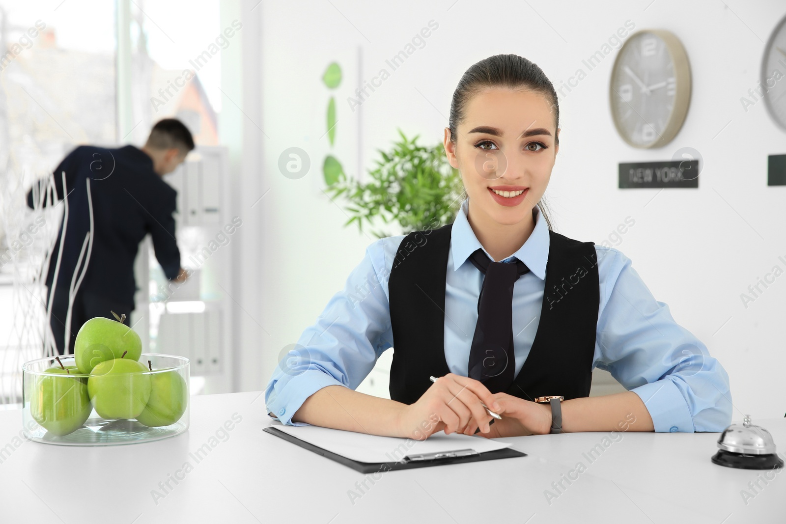 Photo of Busy female receptionist at workplace in hotel