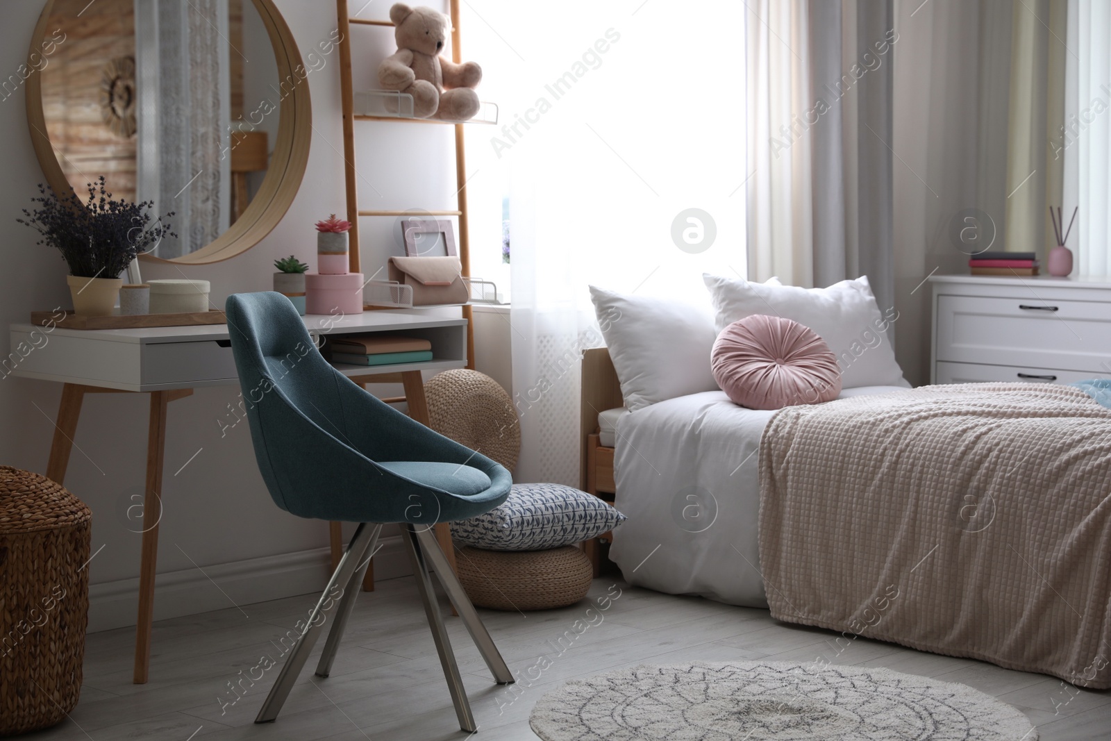 Photo of Teenage girl's bedroom interior with stylish furniture. Idea for design