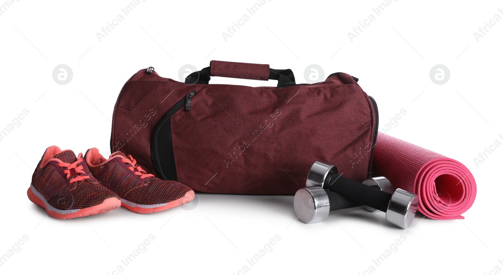 Photo of Sports bag and gym equipment on white background