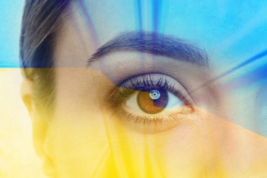 Double exposure of Ukrainian national flag and young woman, closeup view