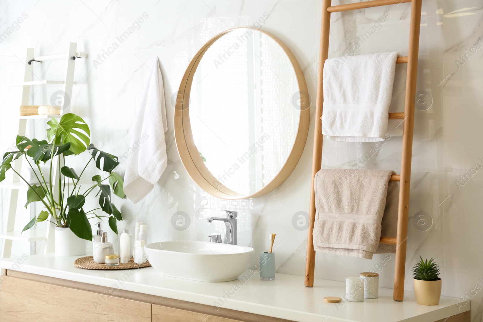 Photo of Decorative ladder near vessel sink in stylish bathroom. Idea for interior design