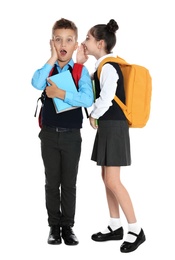 Children in school uniform gossiping on white background