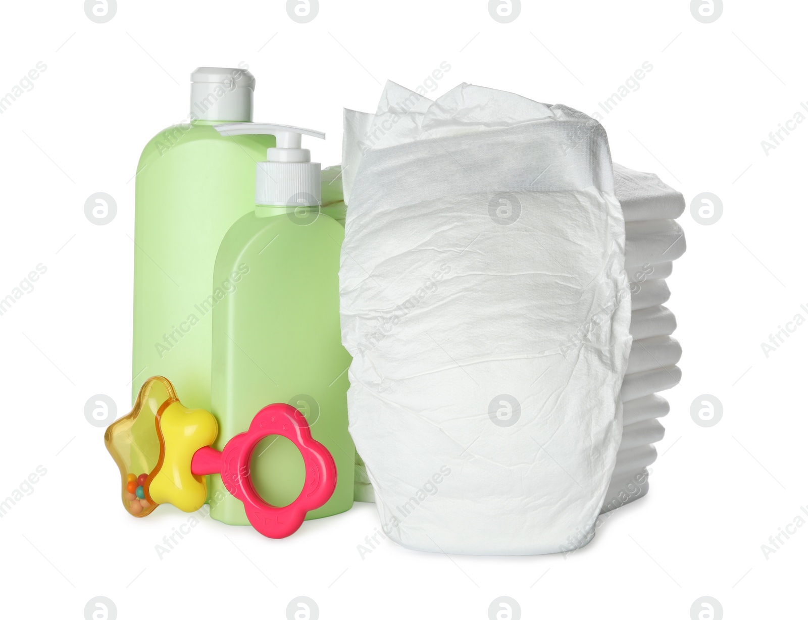 Photo of Disposable diapers, teether and toiletries on white background