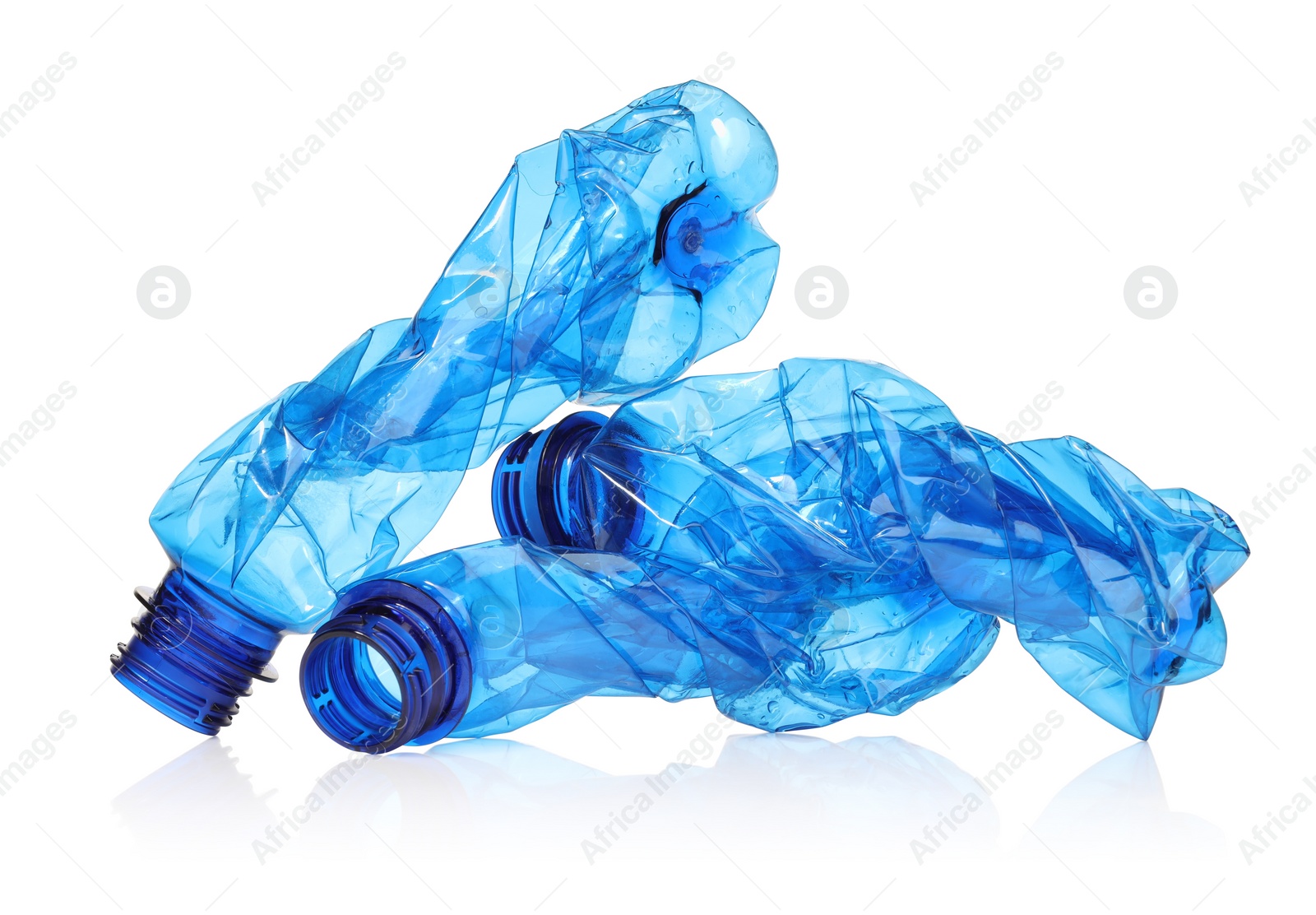 Photo of Crumpled disposable plastic bottles isolated on white