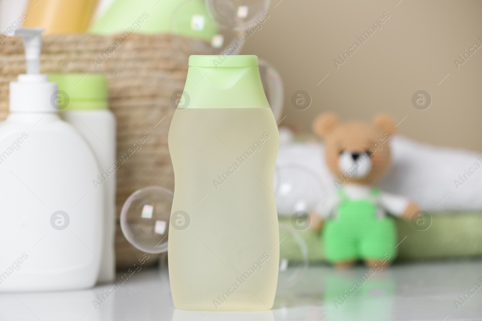 Photo of Bottle of baby cosmetic product on white table