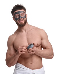 Photo of Handsome man with clay mask on his face against white background