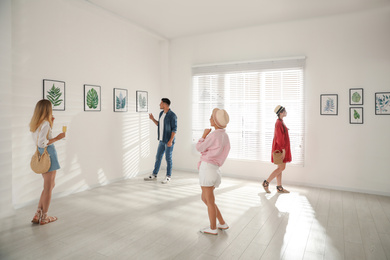 Group of people at exhibition in art gallery