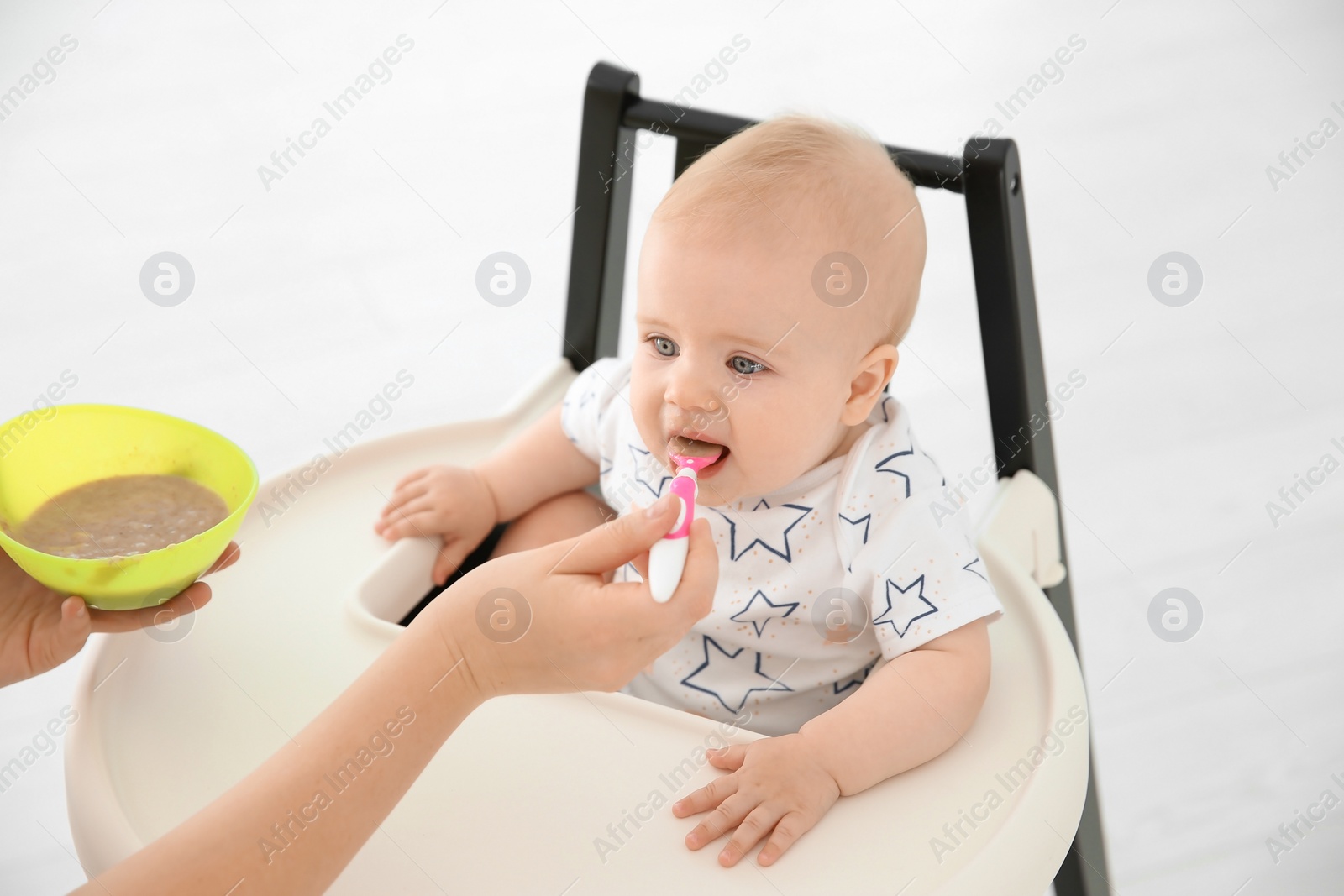 Photo of Mother feeding her cute little baby at home