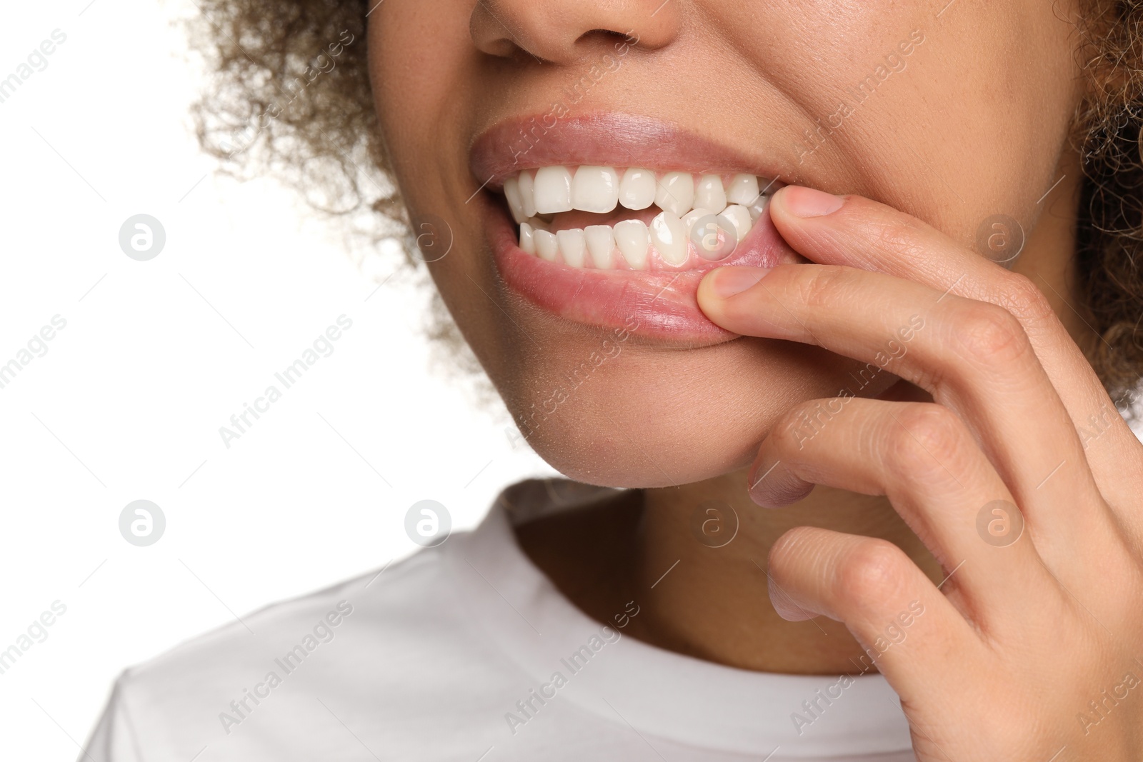 Photo of Woman showing her clean teeth on white background, closeup