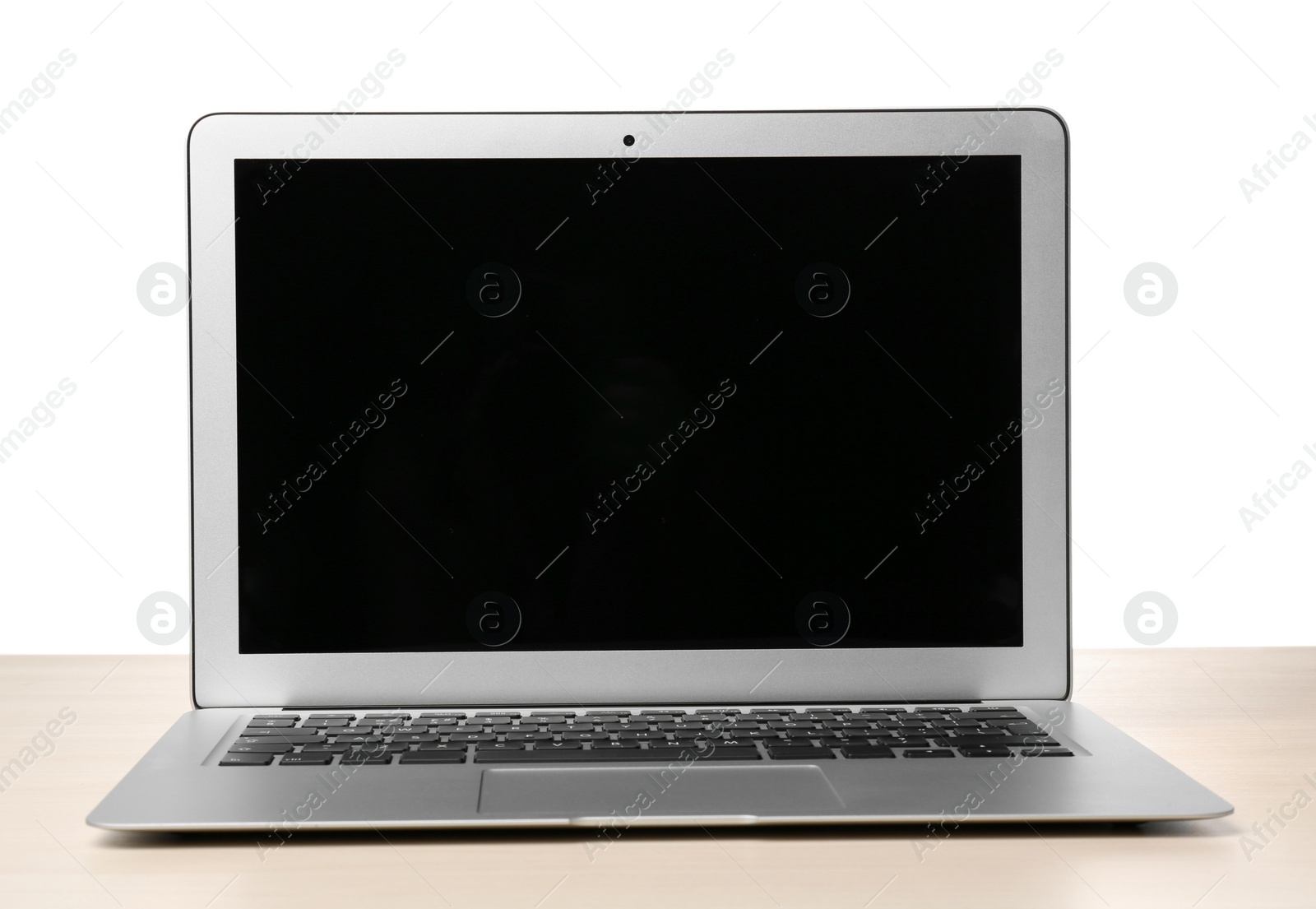 Photo of Modern laptop with blank screen on table against white background