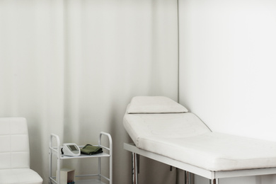 Empty examination couch in modern medical office