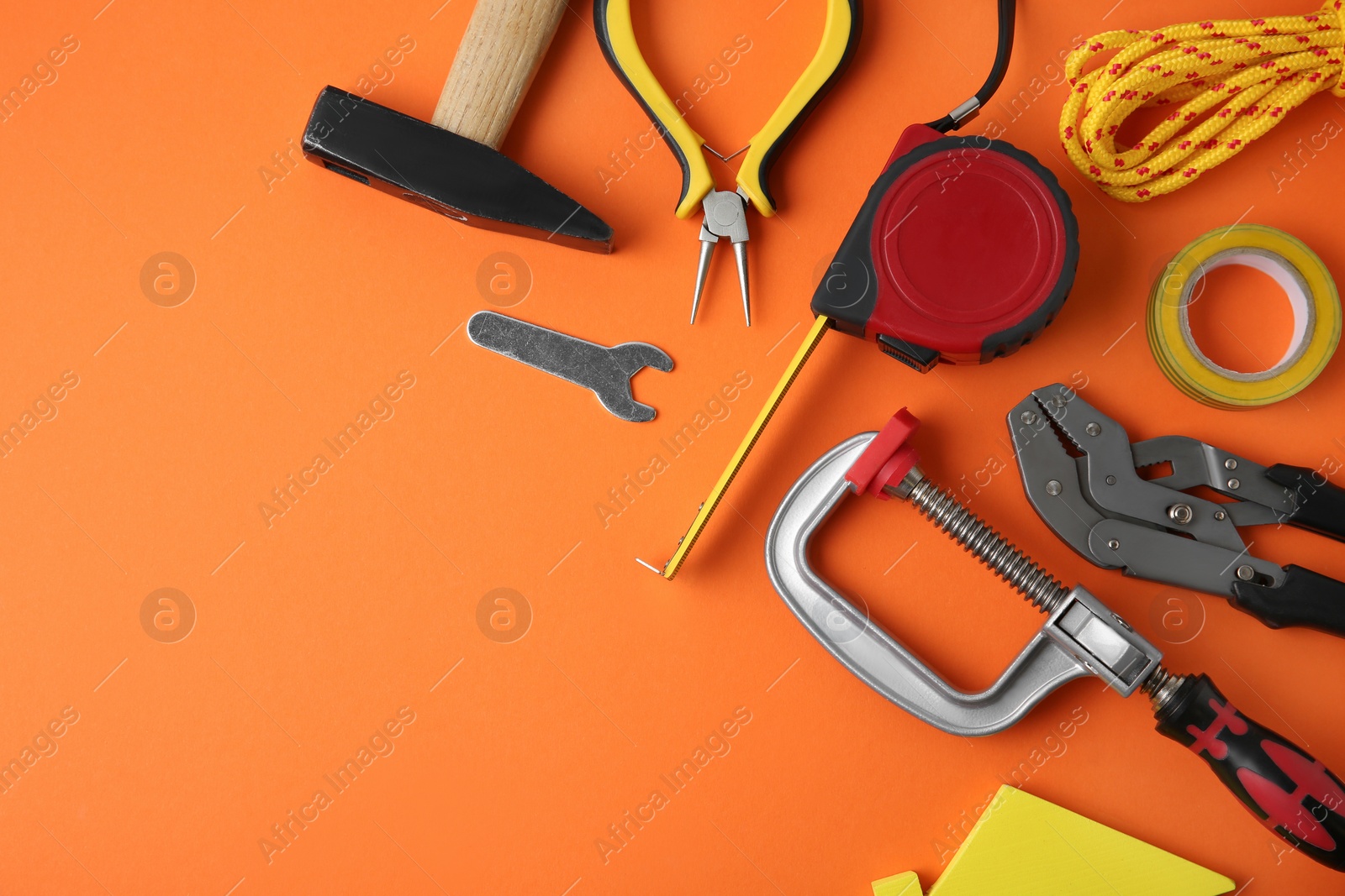 Photo of Set of repair tools on orange background, flat lay. Space for text