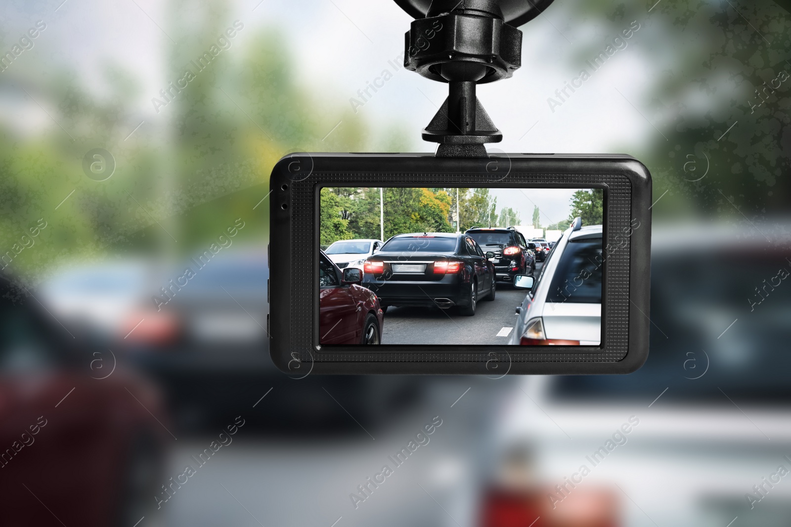 Image of Modern dashboard camera mounted in car, view of road during driving