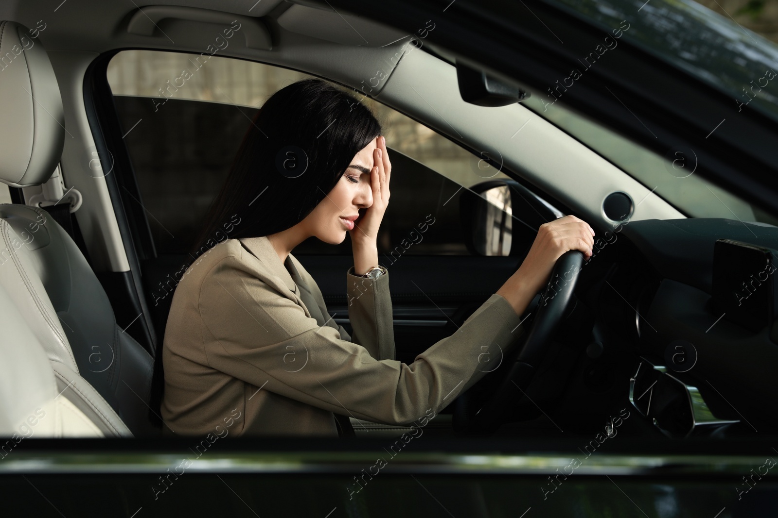 Photo of Stressed young woman driver's seat of modern car