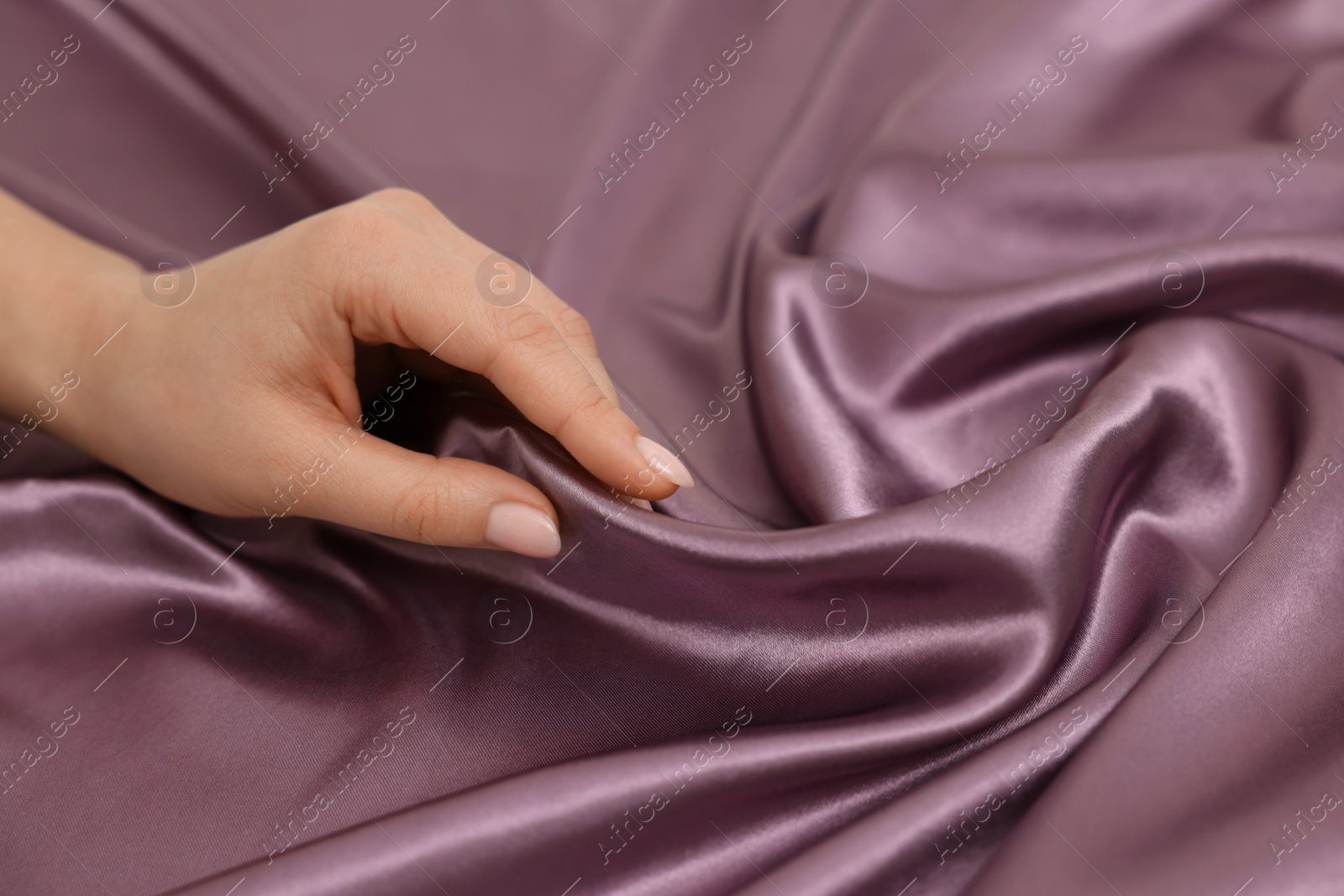 Photo of Woman touching smooth silky fabric, closeup view