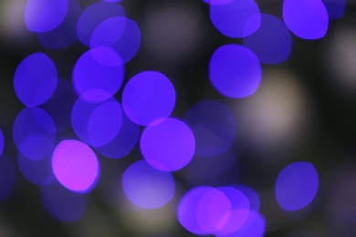 Photo of Blurred view of glowing Christmas lights as background. Festive mood